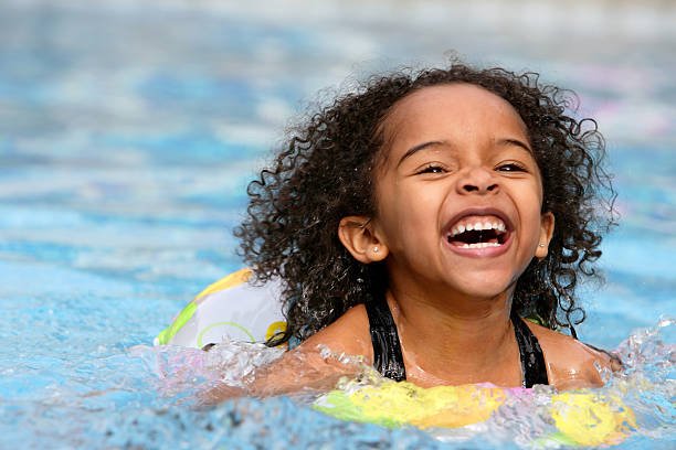 A beautiful African American child swimming